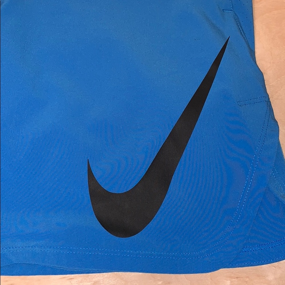 Blue NIKE DRI-FIT woven 9’ shorts, size M.